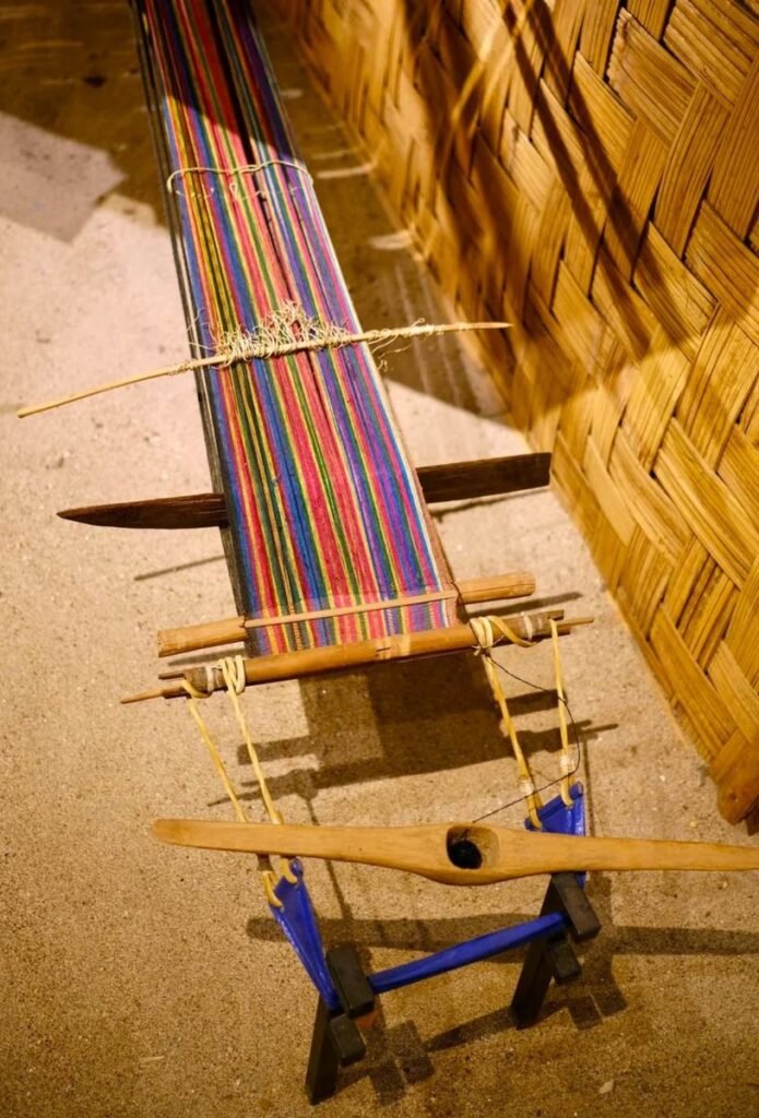 Traditional backstrap loom with colourful warp threads