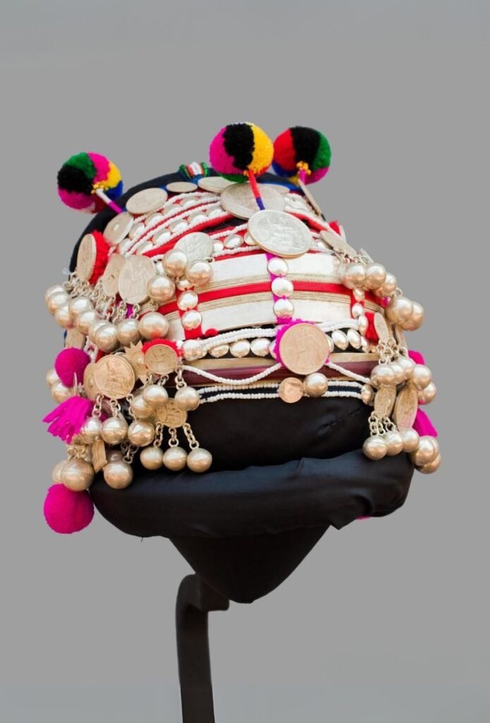 Akha headdress decorated with silver coins, beads and pompoms